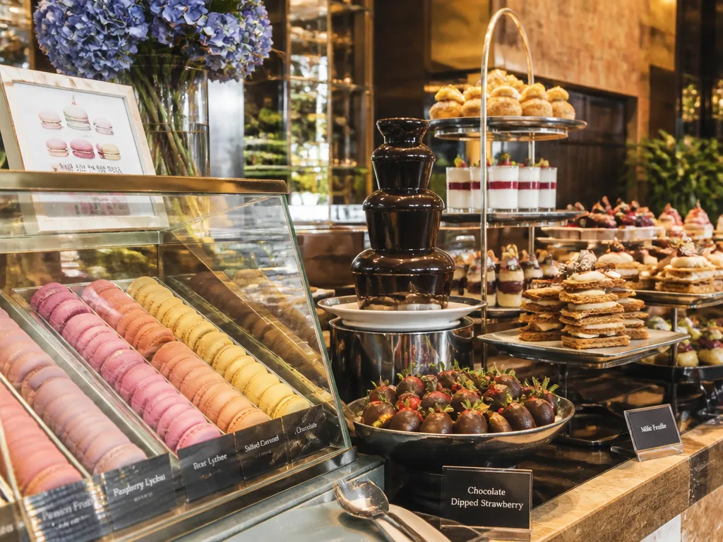 Bangkok hotel brunch dessert station with macarons chocolate fountain and fresh pastries