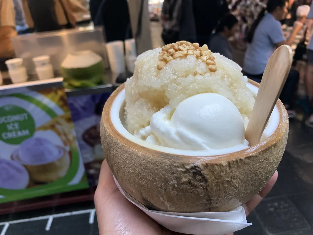Coconut ice cream served inside a halved coconut shell