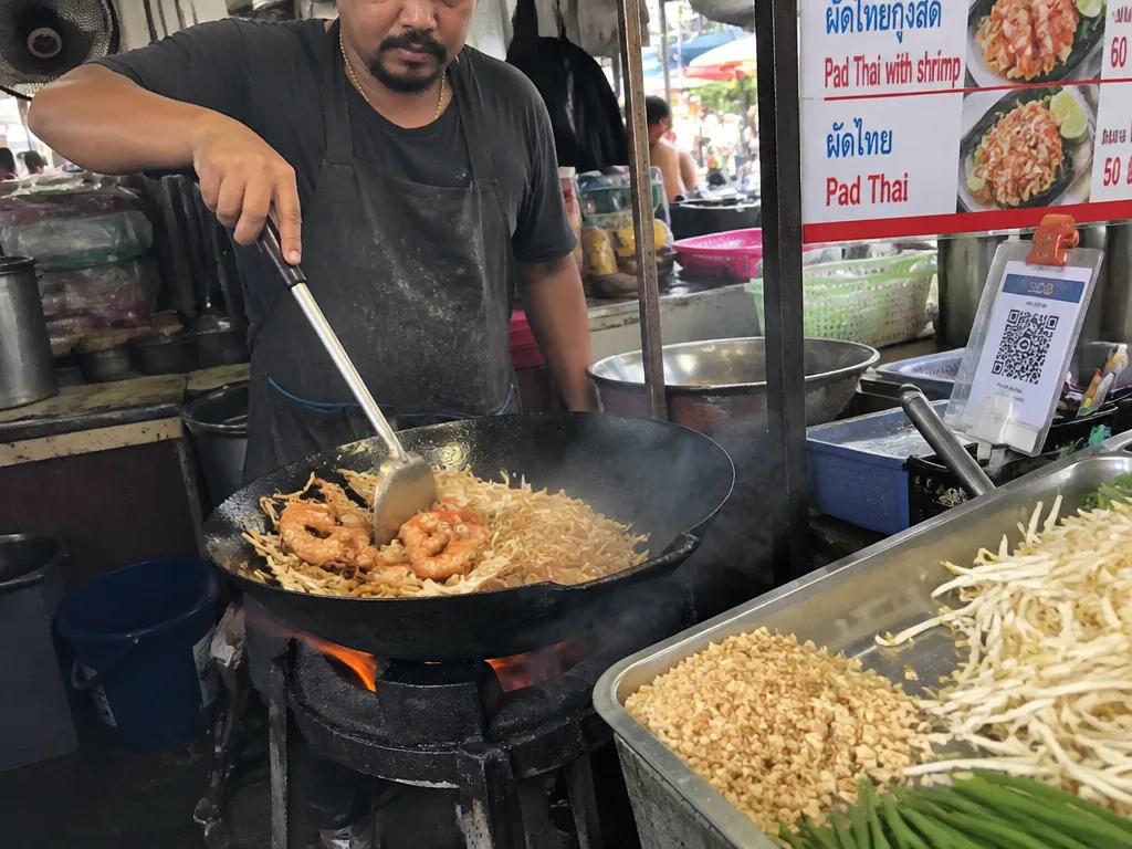 Pad thai cooked over charcoal in a giant blackened wok