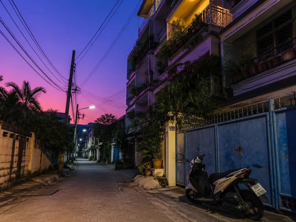Santitham residential side street with low-rise condos at dusk