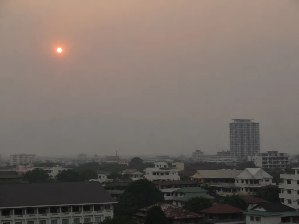 Chiang Mai skyline during burning season with hazy gray-orange sky
