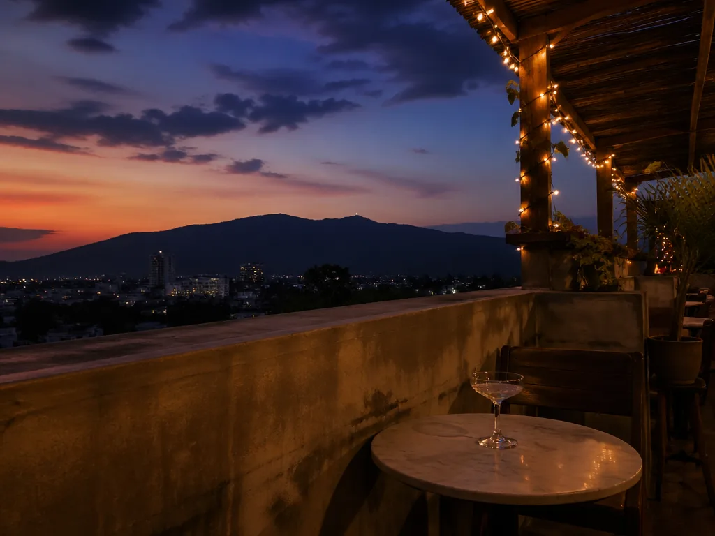 Open-air rooftop bar with mountain silhouette and string lights