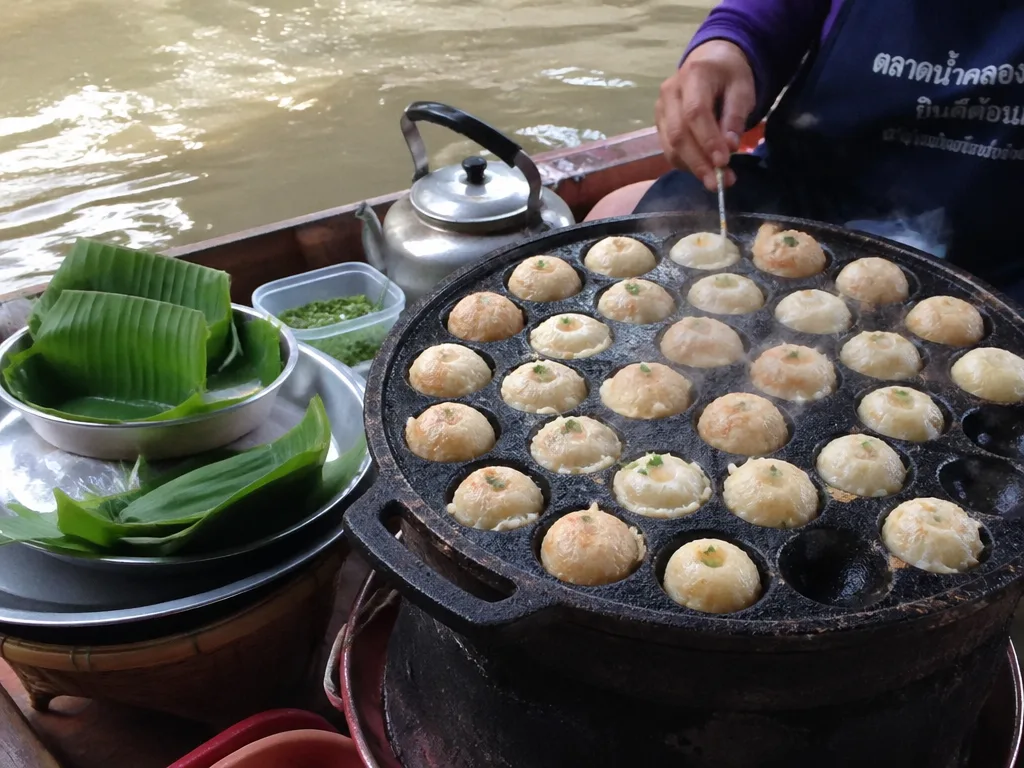 Coconut pancakes khanom khrok cooking in iron pan