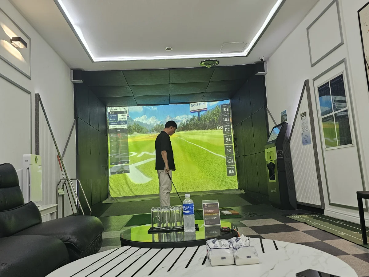 Swinging in a private screen golf room at Golfzon Bangna