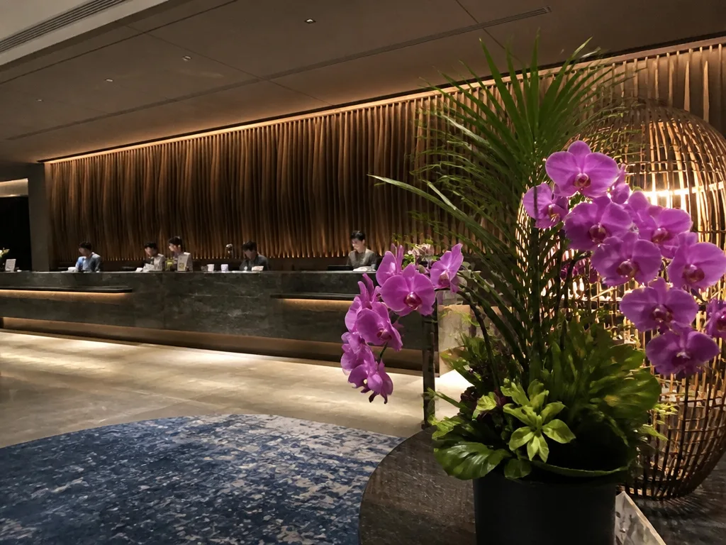 Bangkok hotel reception desk with two staff members checking in guests