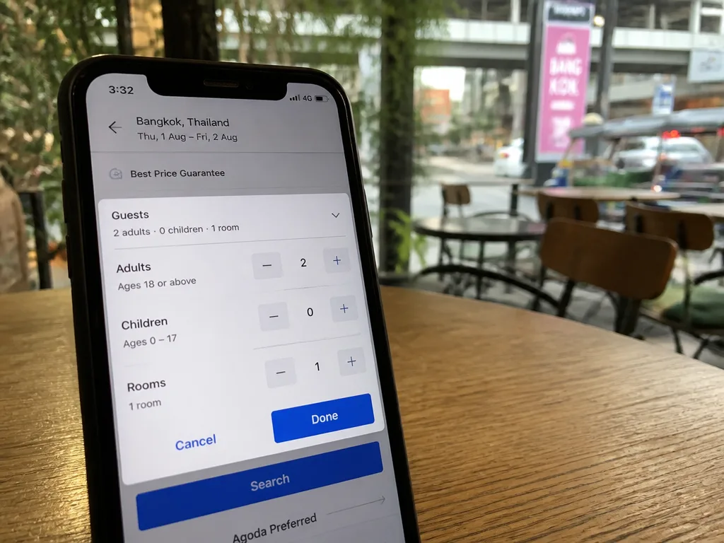 Smartphone showing hotel booking app with two adult guest count selected
