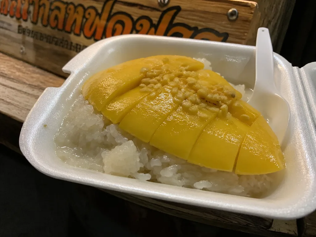 Mango sticky rice portion in a foam container at a Koh Samui market cart
