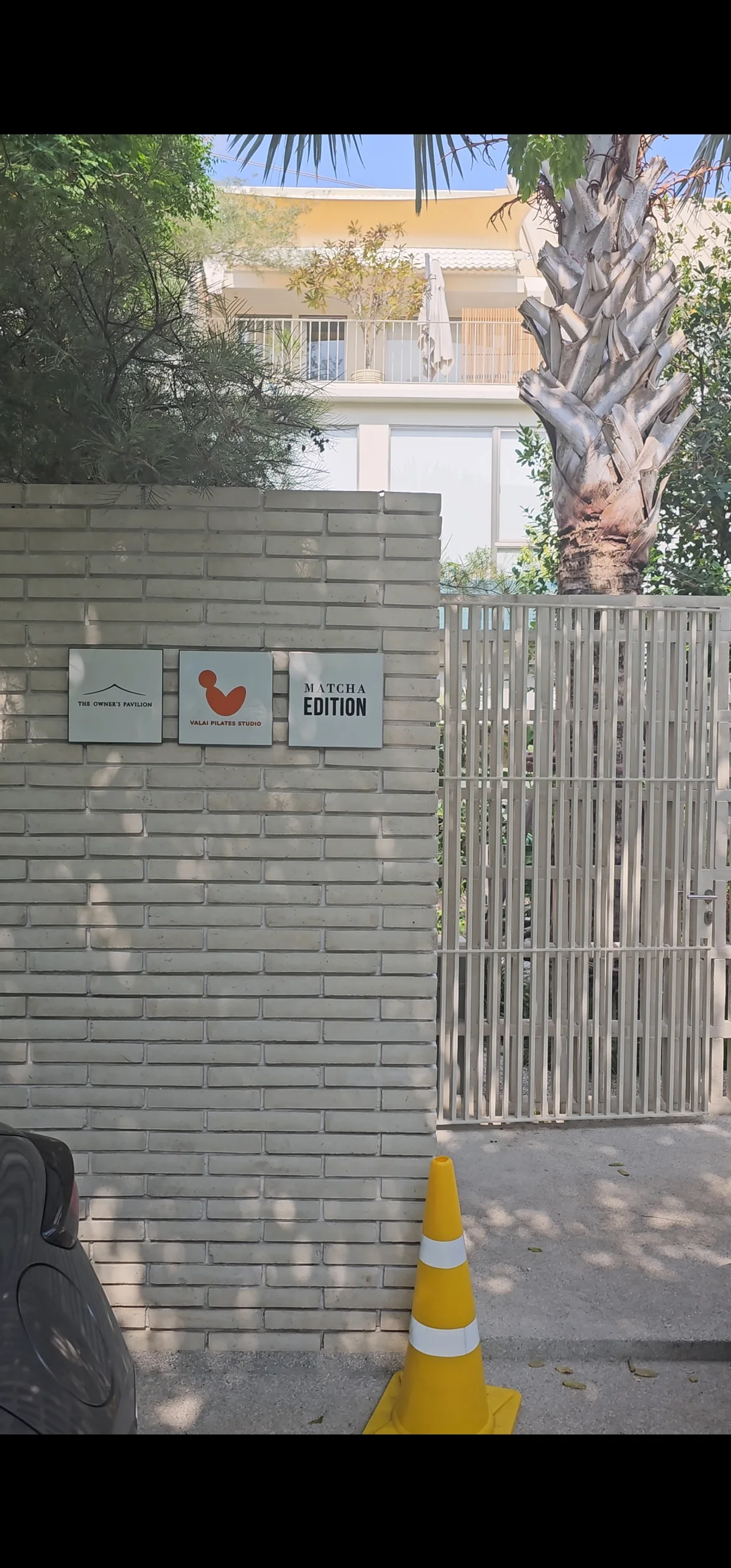 Matcha Edition gate sign on a brick wall in Bangkok