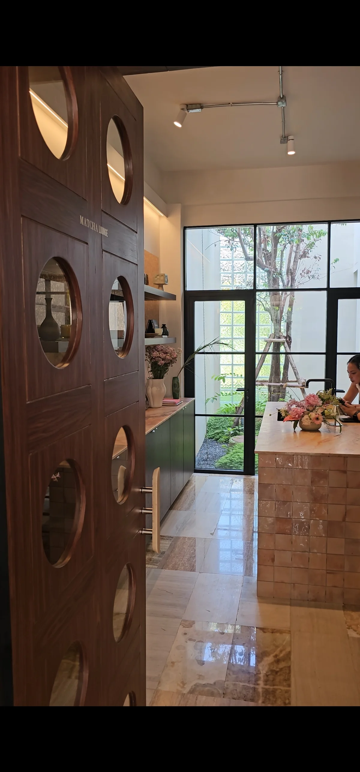 Matcha Lounge interior with marble floor and garden window