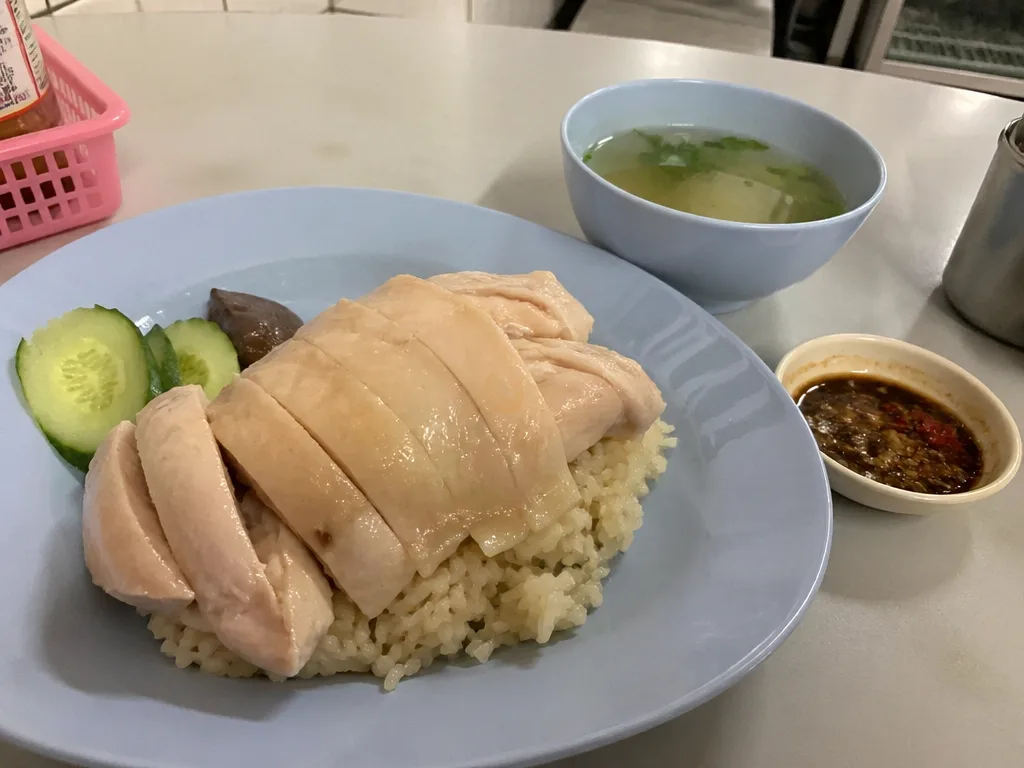 Pratunam chicken rice plate with poached chicken and ginger chili sauce