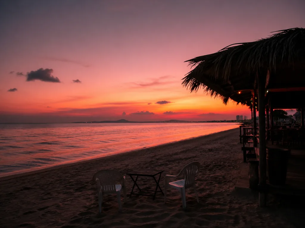 Jomtien Beach sunset with calm sea and small wooden bar shack