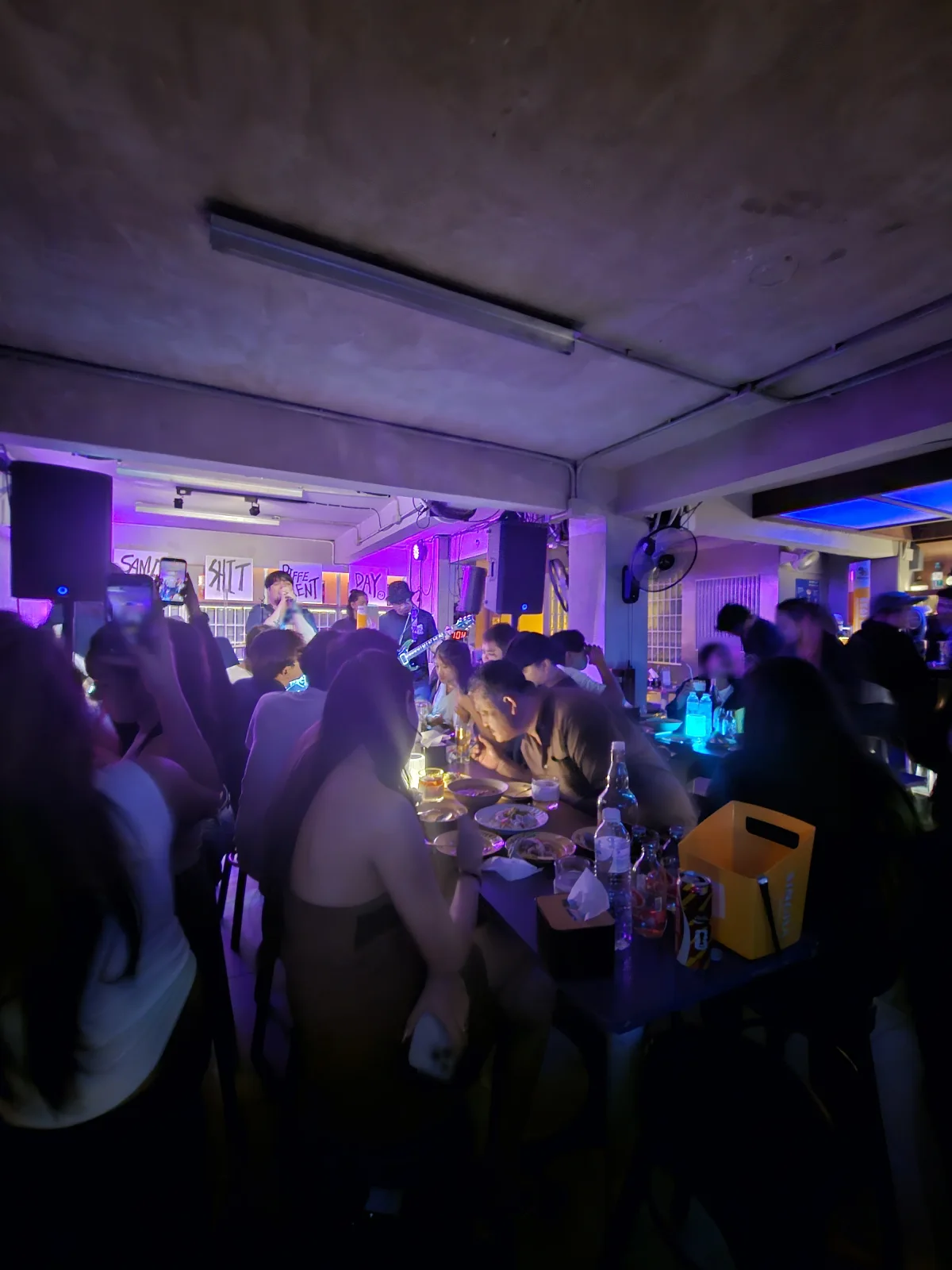 Packed crowd under purple light inside SSDD
