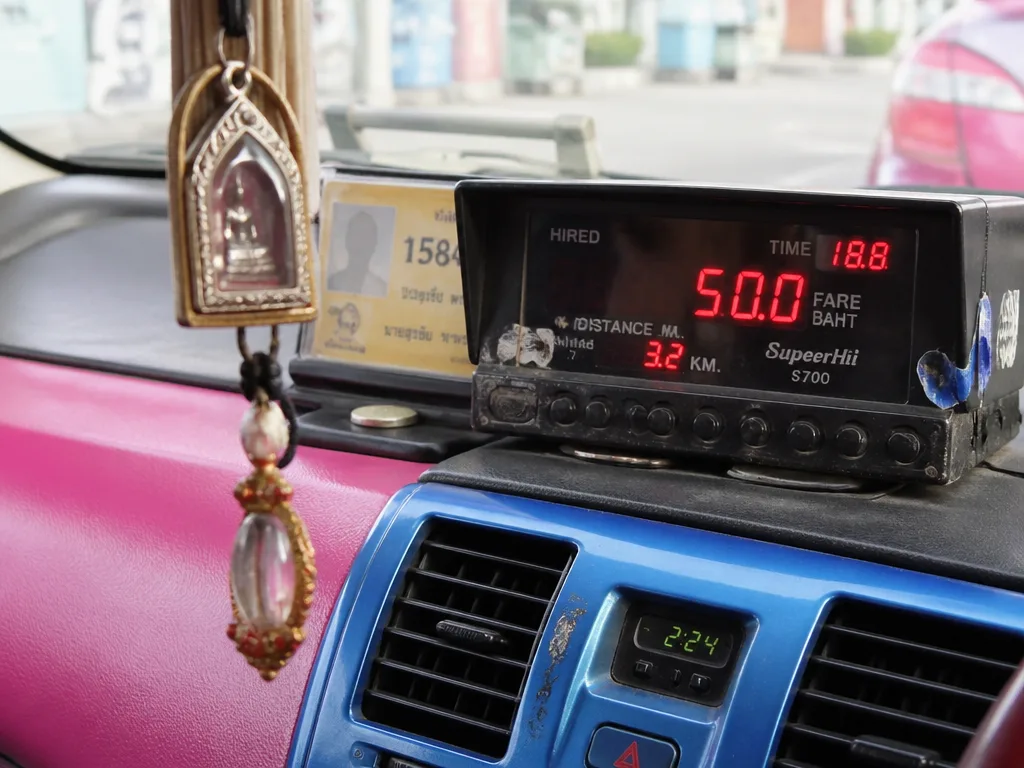 Bangkok metered taxi dashboard with red LED meter