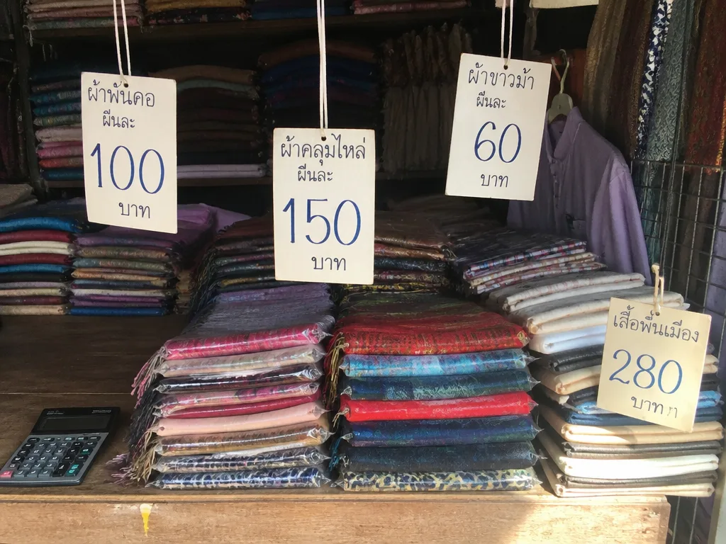 Bangkok market stall with hanging price tags in Thai