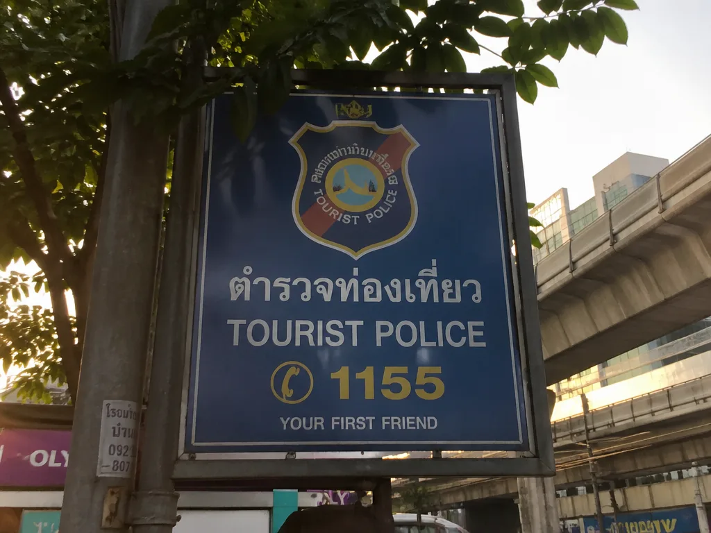 Tourist police signboard at Bangkok street corner