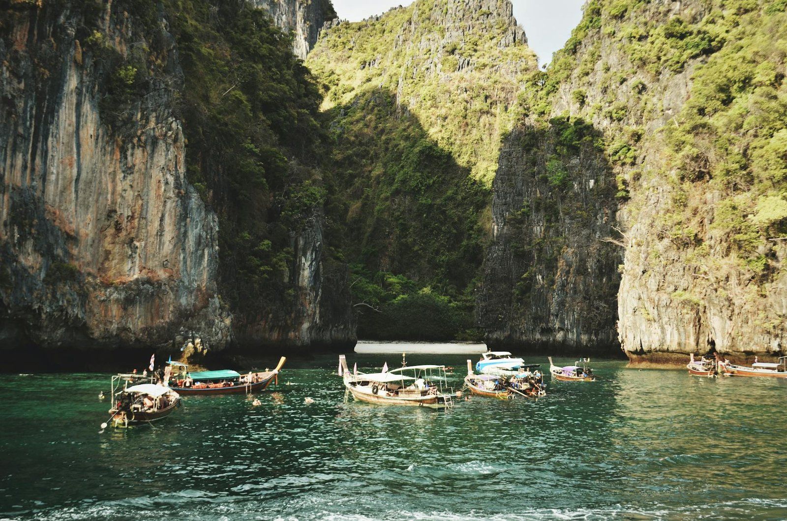 Longtail boat by limestone karsts