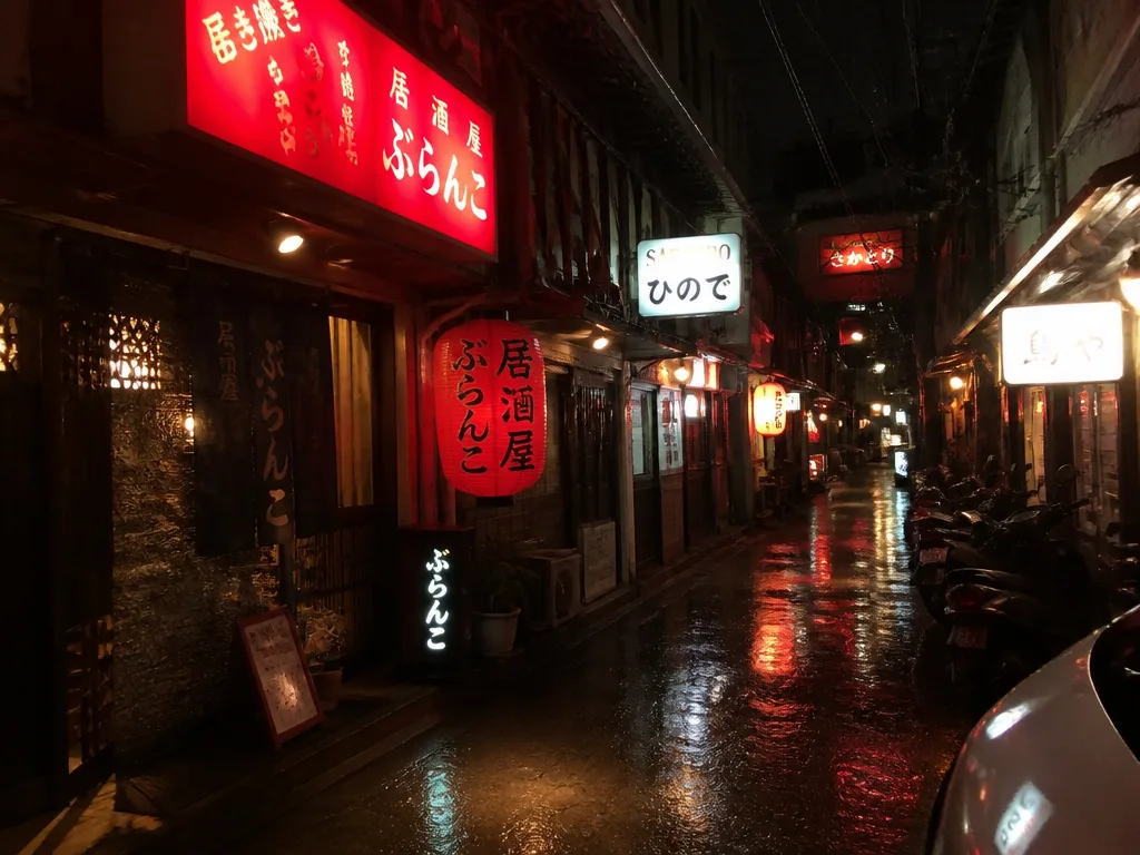 Thonglor neon-lit side alley with Japanese izakaya signage at night